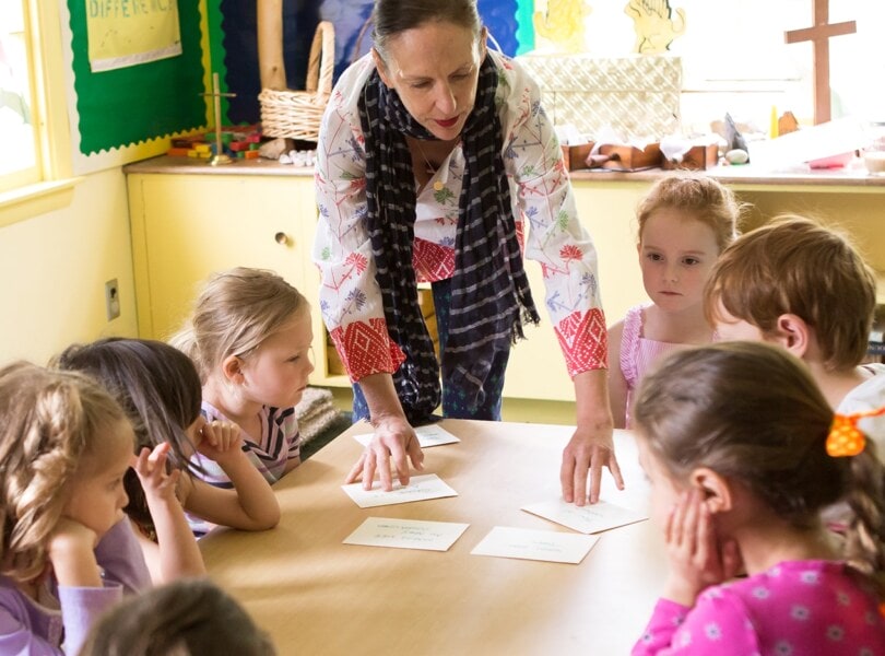 A woman teaches a Sunday School class to young children.
