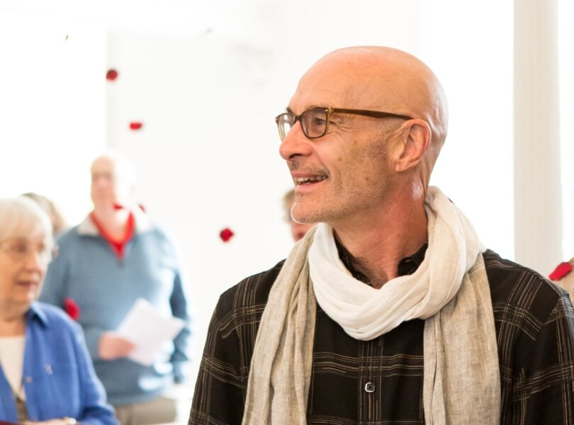 A man smiling in worship at the First Congregational Church of Stockbridge