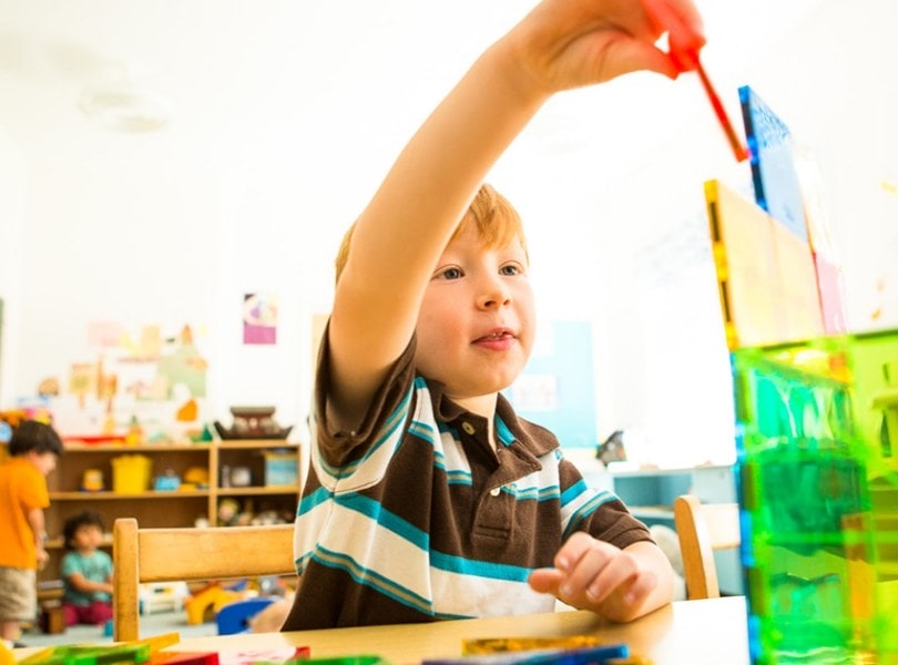 A boy plays with magnetiles in the nursery of the Stockbridge Congregational Church