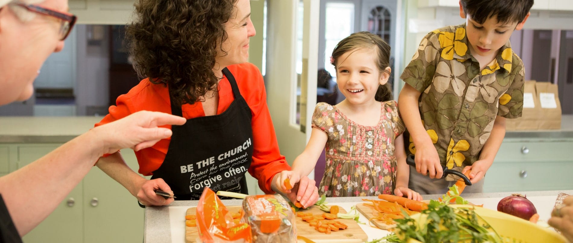 A girl, boy, and their mother prep a meal for homeless in the Berkshires, in the kitchen of the Stockbridge Congregational Church