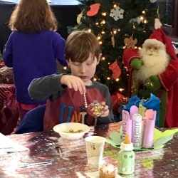 A boy makes Christmas ornaments