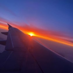 The wing of a plane as the sun rises