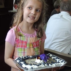 A girl carries a cake