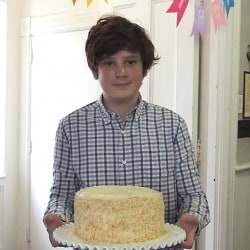 A boy shows off his cake