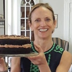A woman carries a cake
