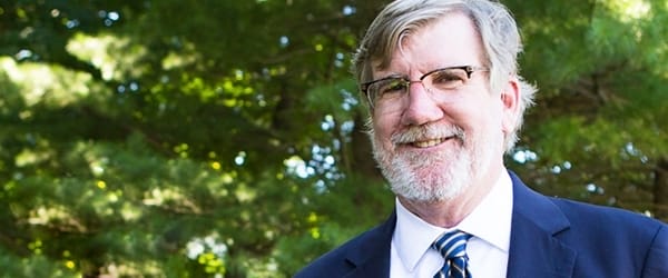 A bearded man smiling