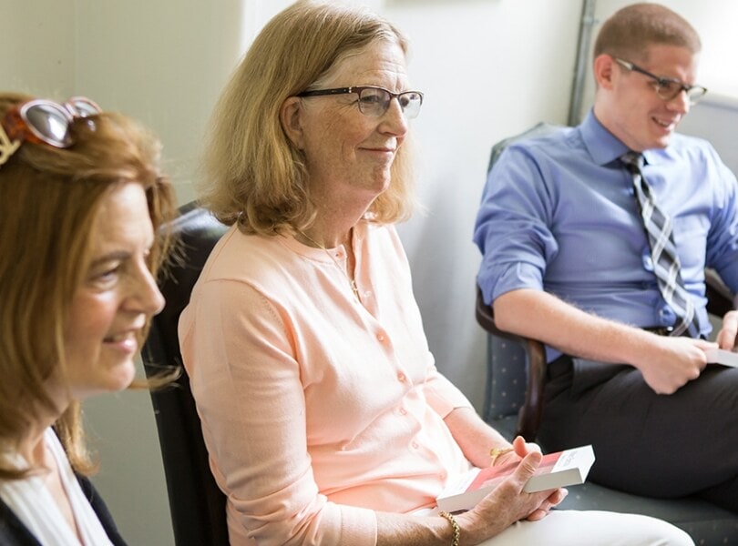 Two women and a man engage in coversation about the Bible