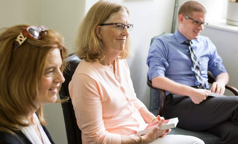 Two women and a man engage in coversation about the Bible