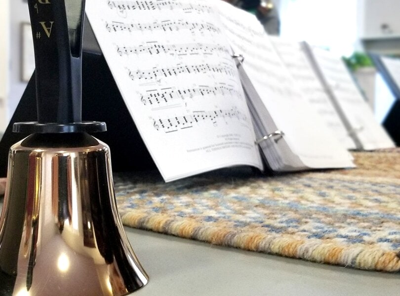 A handbell with sheet music