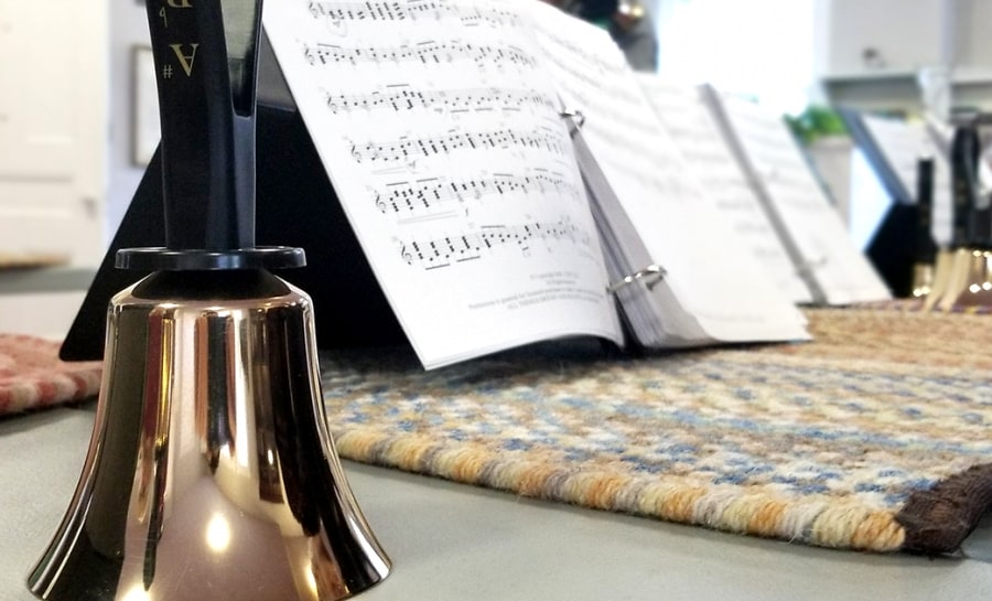 A handbell with sheet music