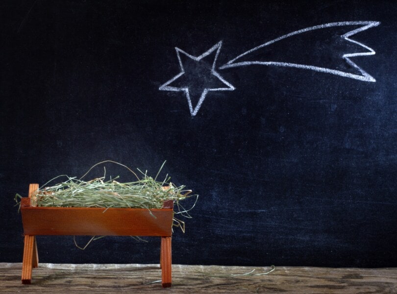A manger and star on blackboard.