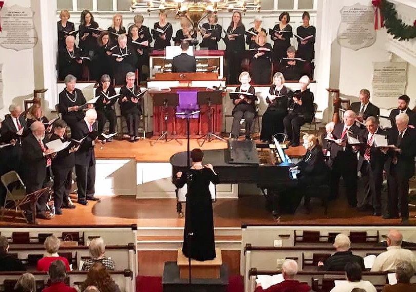 A choral group sings in a church sanctuary