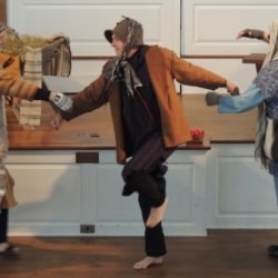 Three shepherds dance with one another