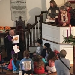Children listen to the pastor's message featuring emojis