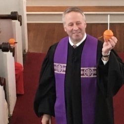 Pastor Brent shows off a completed Christingle